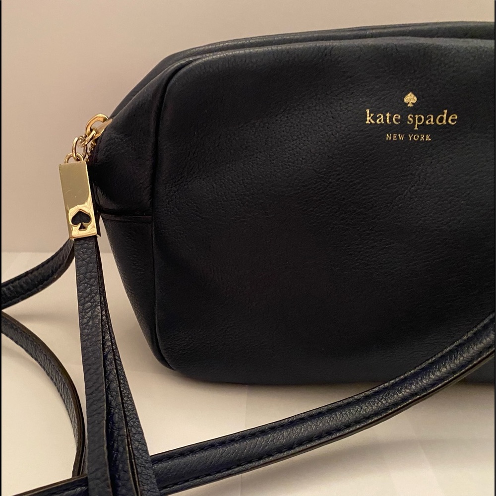 This genuine leather zip up purse is a dark navy blue.